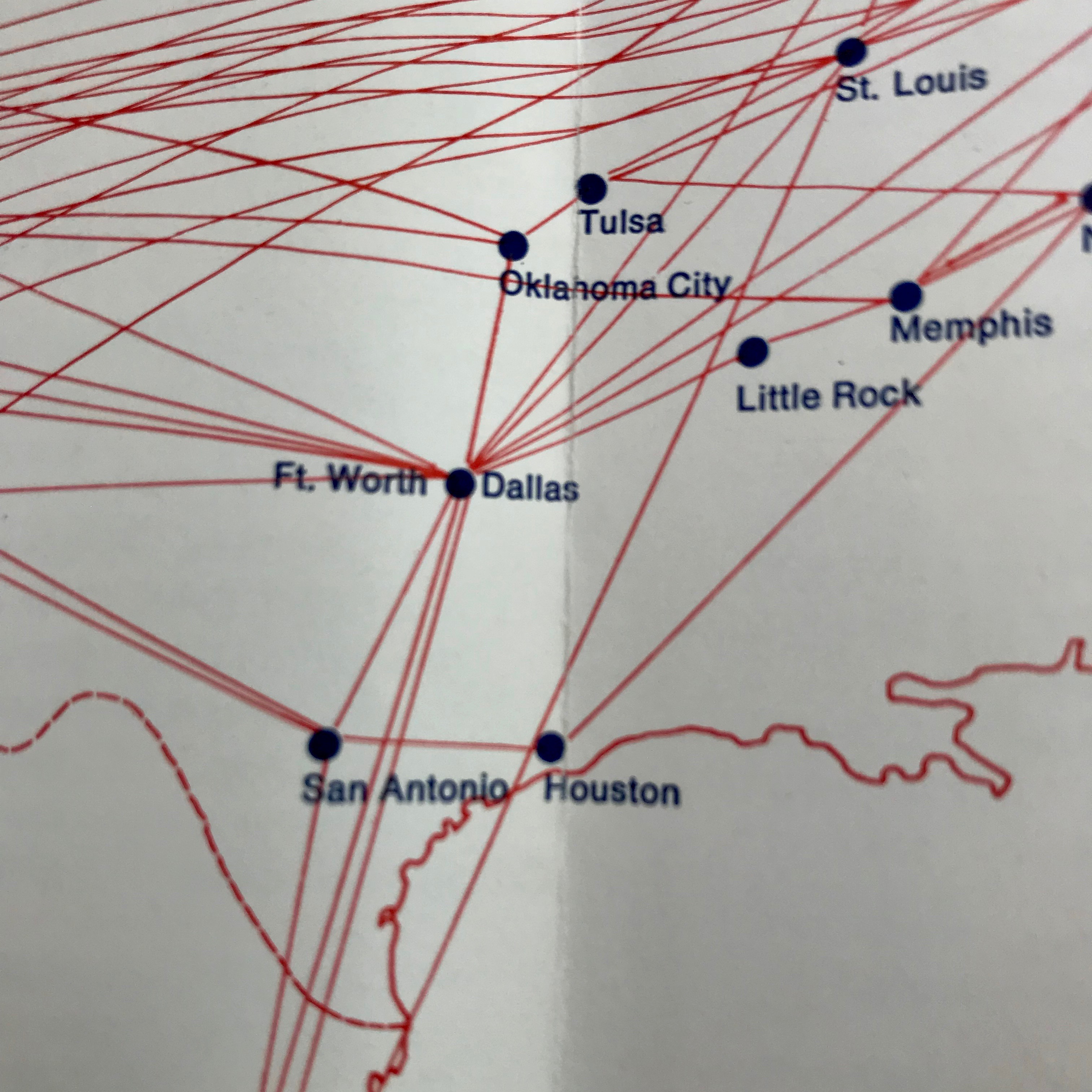 A close up of the American Airlines route map from 1969, with dots of cities in Texas like Houston in black with red lines connecting the dots to indiate flight options. 