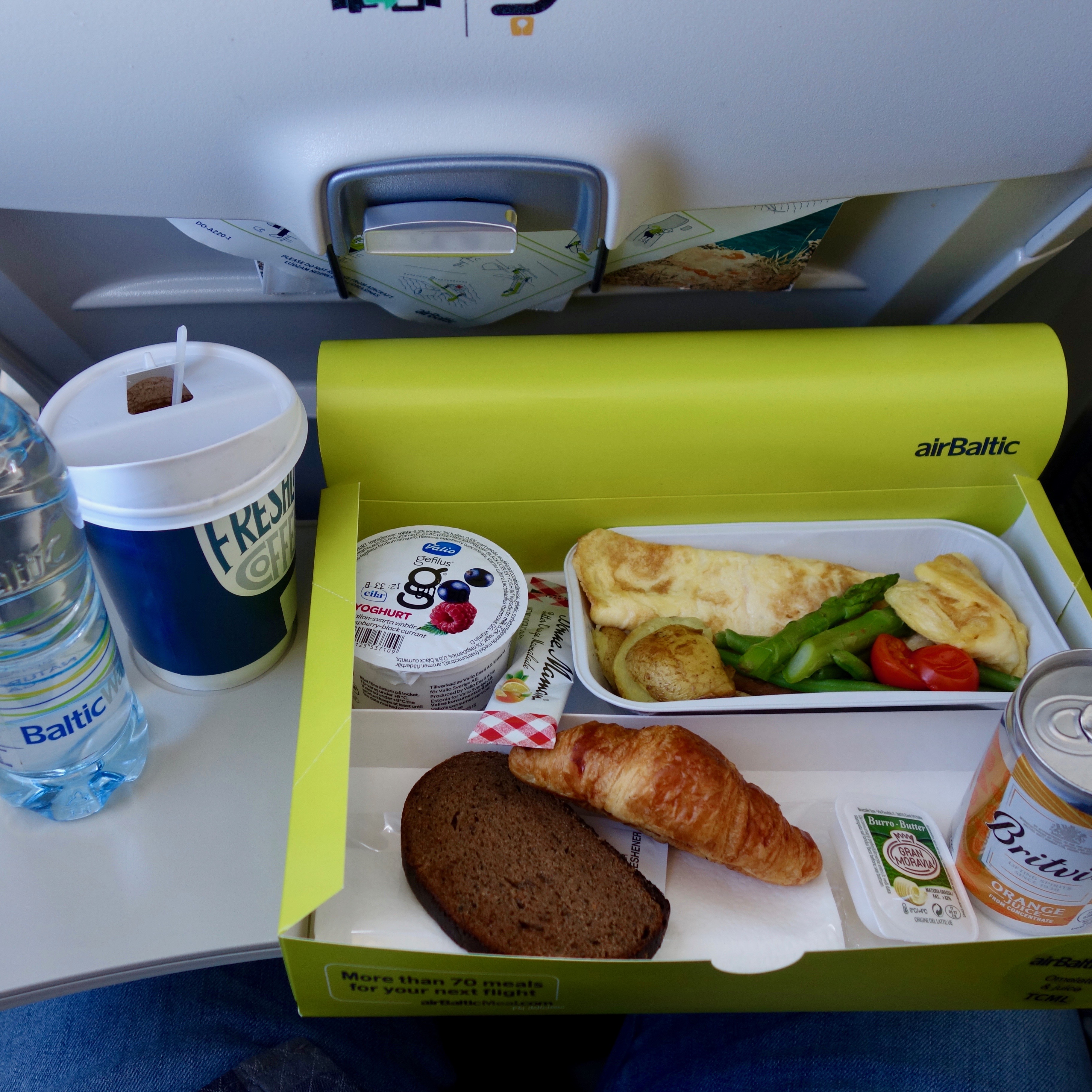 This review of the experience on an airBaltic Airbus A220 also includes focus on the inflight meal served for purchase.  This kit contains an omelette, croissant and beverages.  