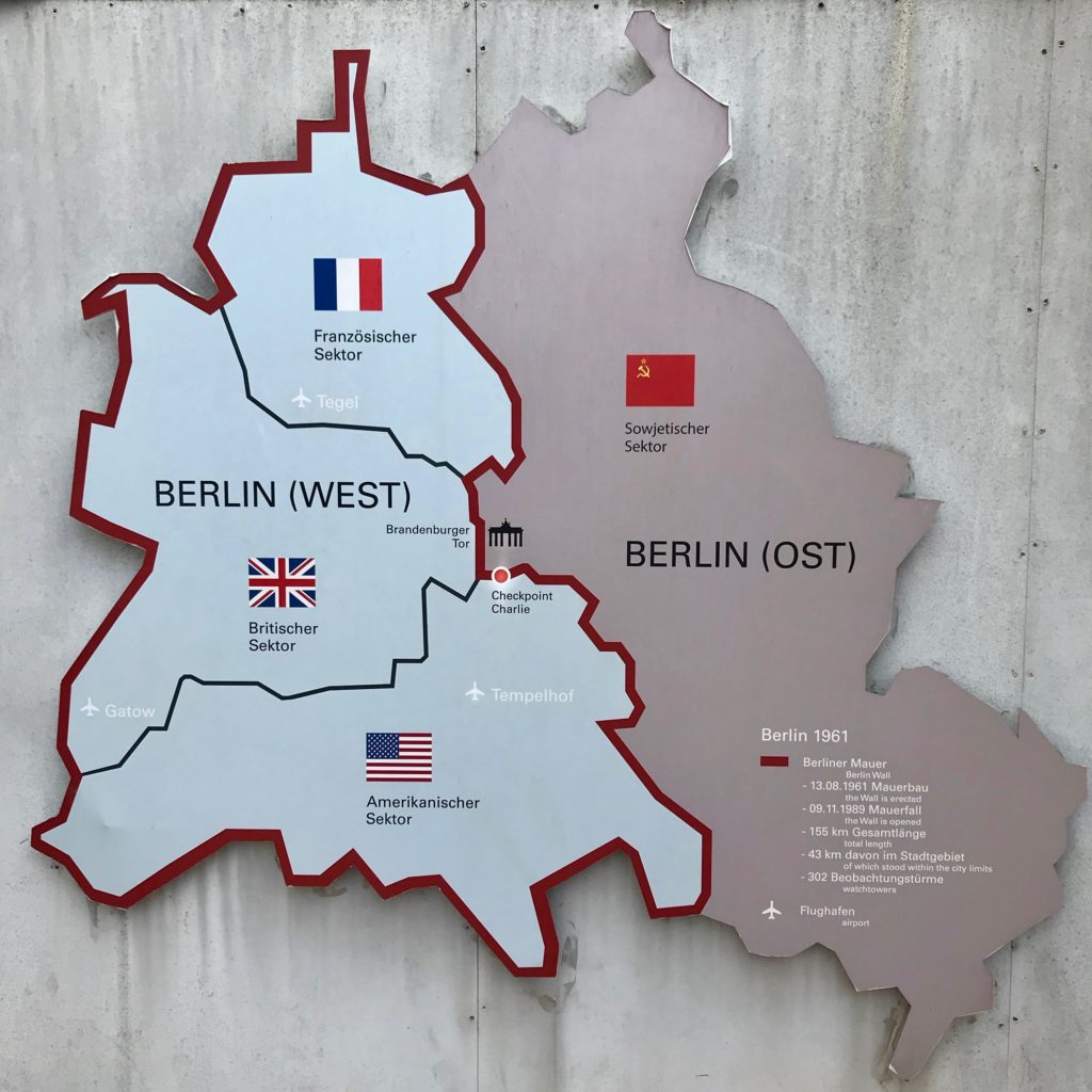 In order to honor the history of Berlin, it's first important to understand the politics involved.  Map on the wall of Checkpoint Charlie area showing the way Berlin was divided up between the four remaining powers in the world.