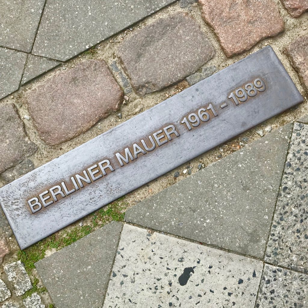 The Berlin Wall is perhaps the number one item on the top ten list of ways to honor Berlin history.  Placard on the cobblestone street marking the line where the Berlin Wall once stood.