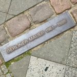 Placard on the cobblestone street marking the line where the Berlin Wall once stood.