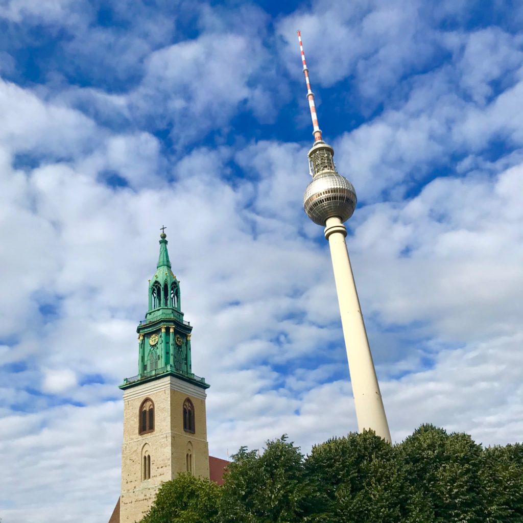 Berlin TV tower rises above Alexanderplatz and nearby St. Marienkirche