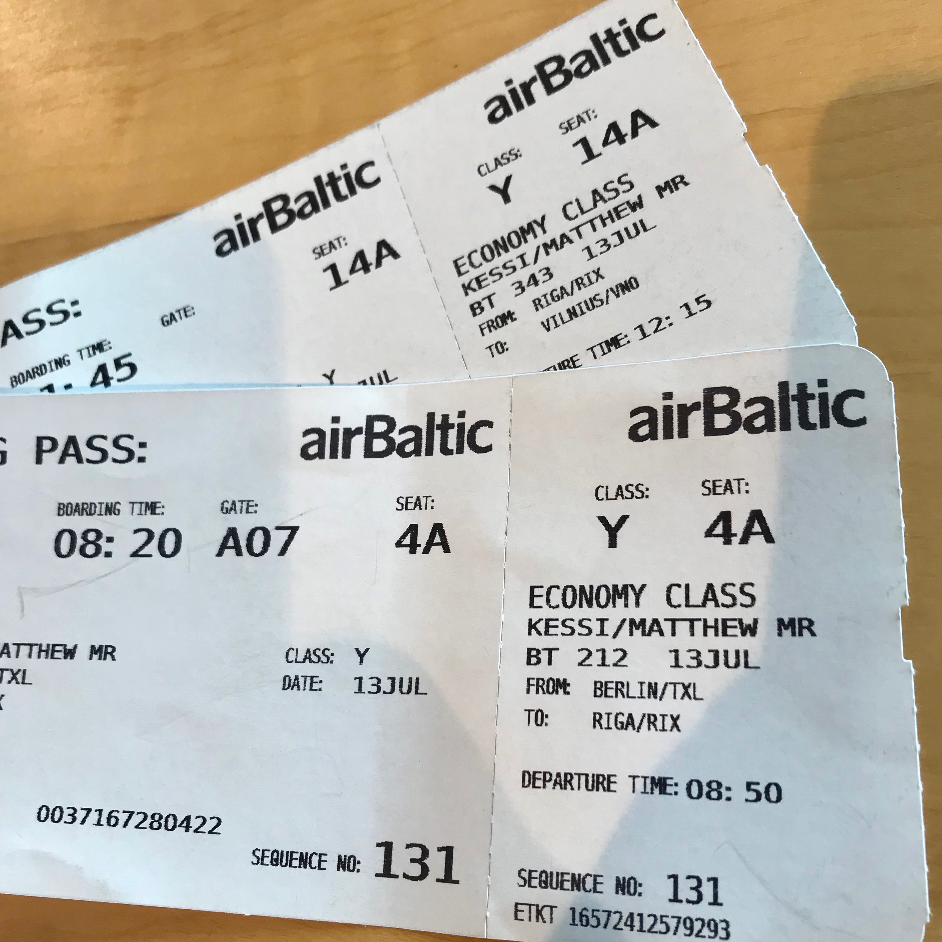 Two passenger boarding cards for a flight from Berlin Tegel to Riga.  The airBaltic tickets are on white paper with black lettering and a perforated edge where a stub could be ripped off upon boarding.  