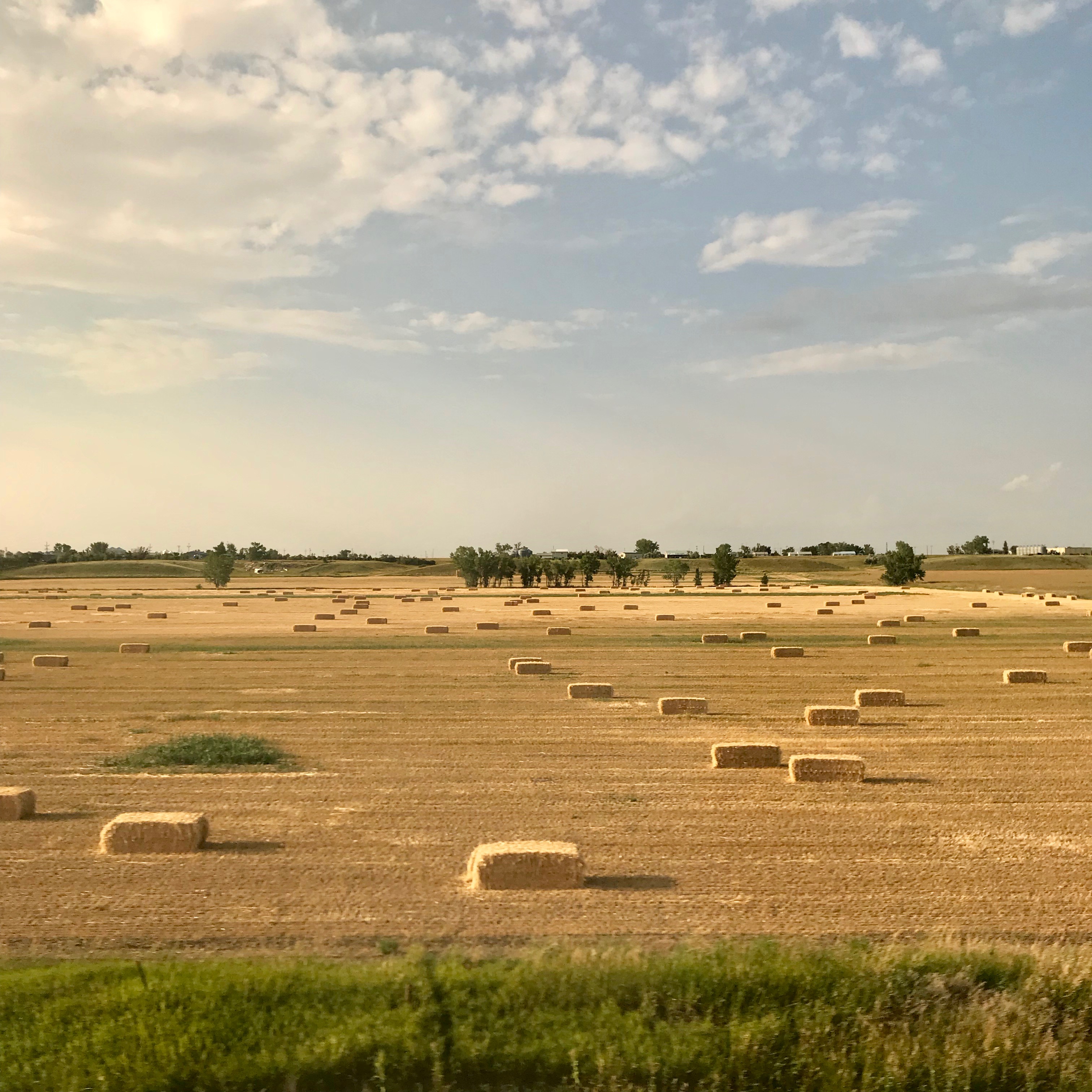 Hay bales on a lazy August afternoon somewhere in eastern Montana as viewed from the long-distance Amtrak train Empire Builder. 