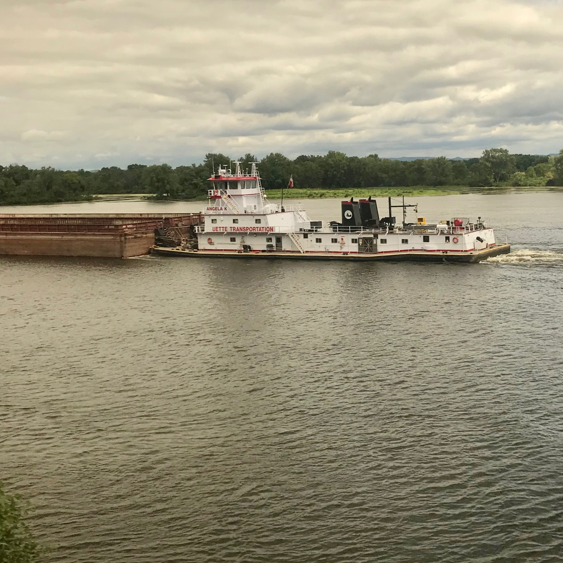 View of a tugboat on the Mississippi River from the sleeping car of Amtrak Empire Builder, traveling from Seattle to Chicago.