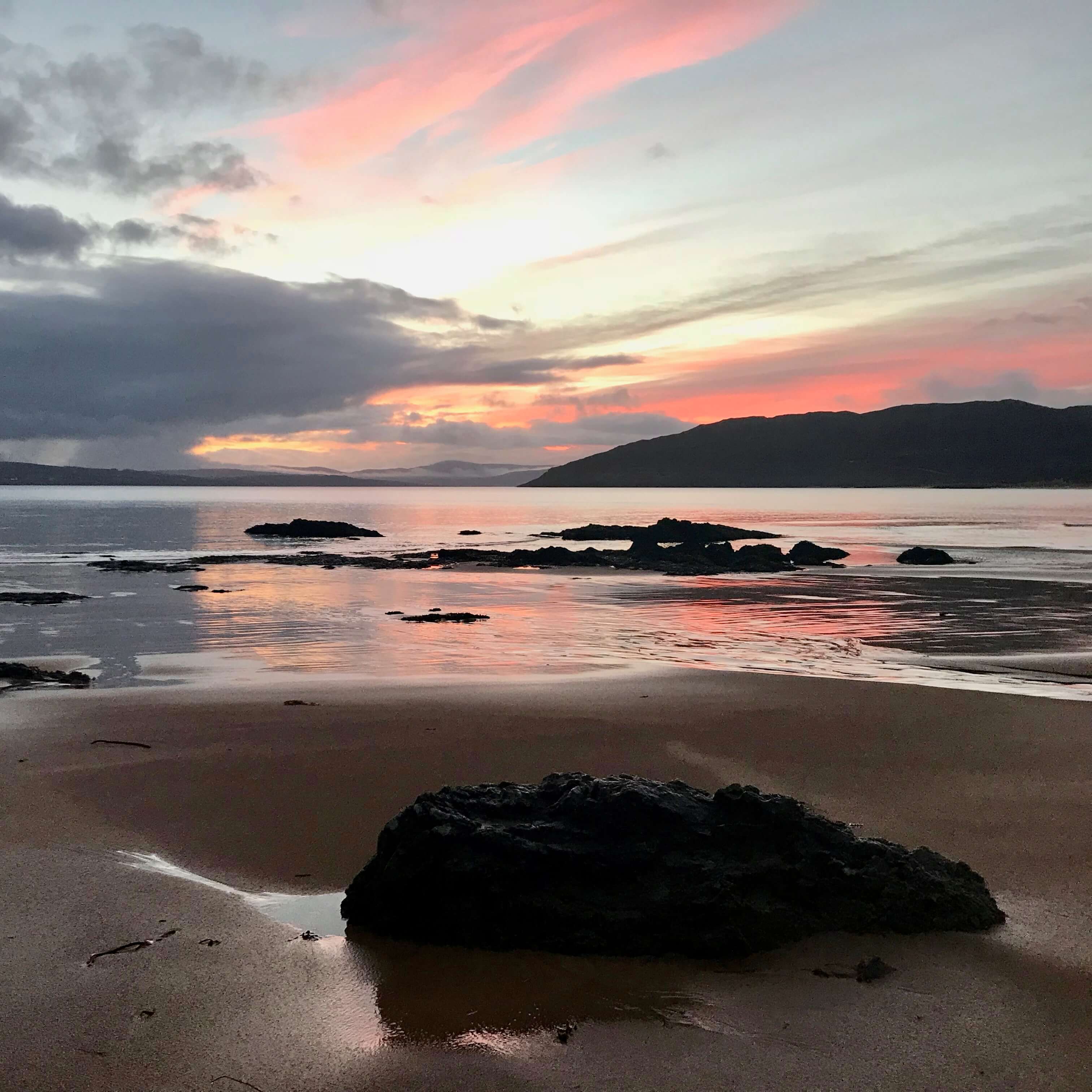 Beautiful Portsalon Beach at sunrise on a brisk Irish winter morning.  Located in the Irish northwest county of Donegal.  I flew to Ireland and want to reduce my travel carbon impact through purchasing offsets.