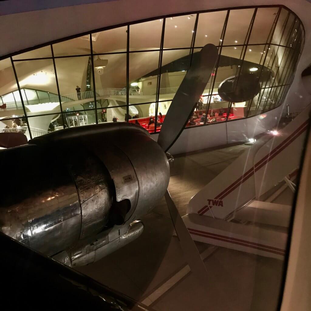 Looking out the window from a cocktail lounge located inside a vintage Lockheed Super Constellation flown by TWA in 1962 when the Historic Eero Saarinen JFK Airport Terminal was completed. This aircraft is now displayed outside the TWA Hotel.