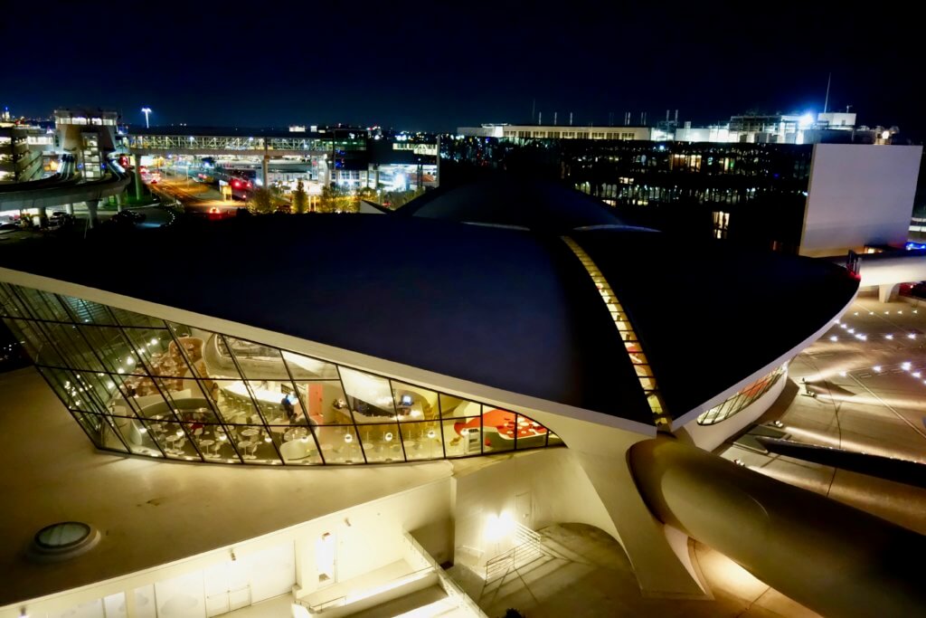 Nighttime view of the Eero Saarinen Terminal from the vantage point of the rooftop pool. The iconic building is now the main feature of the TWA Hotel.
