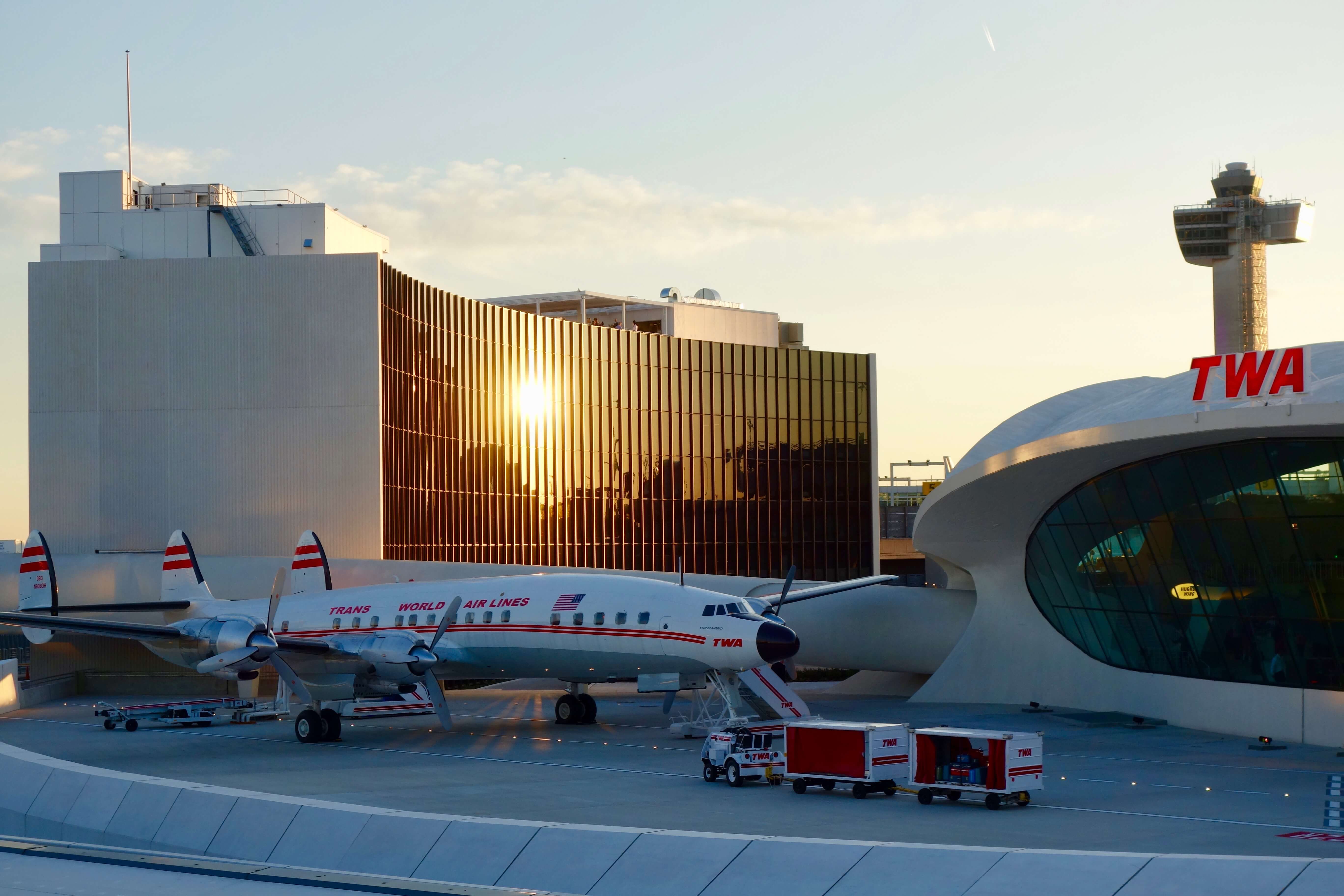 Outside view from JFK Terminal 5 looking toward the iconic Eero Saarinen terminal building completed in 1962 for TWA. In the forefront is a vintage TWA Super Constellation, also know as the "Connie."