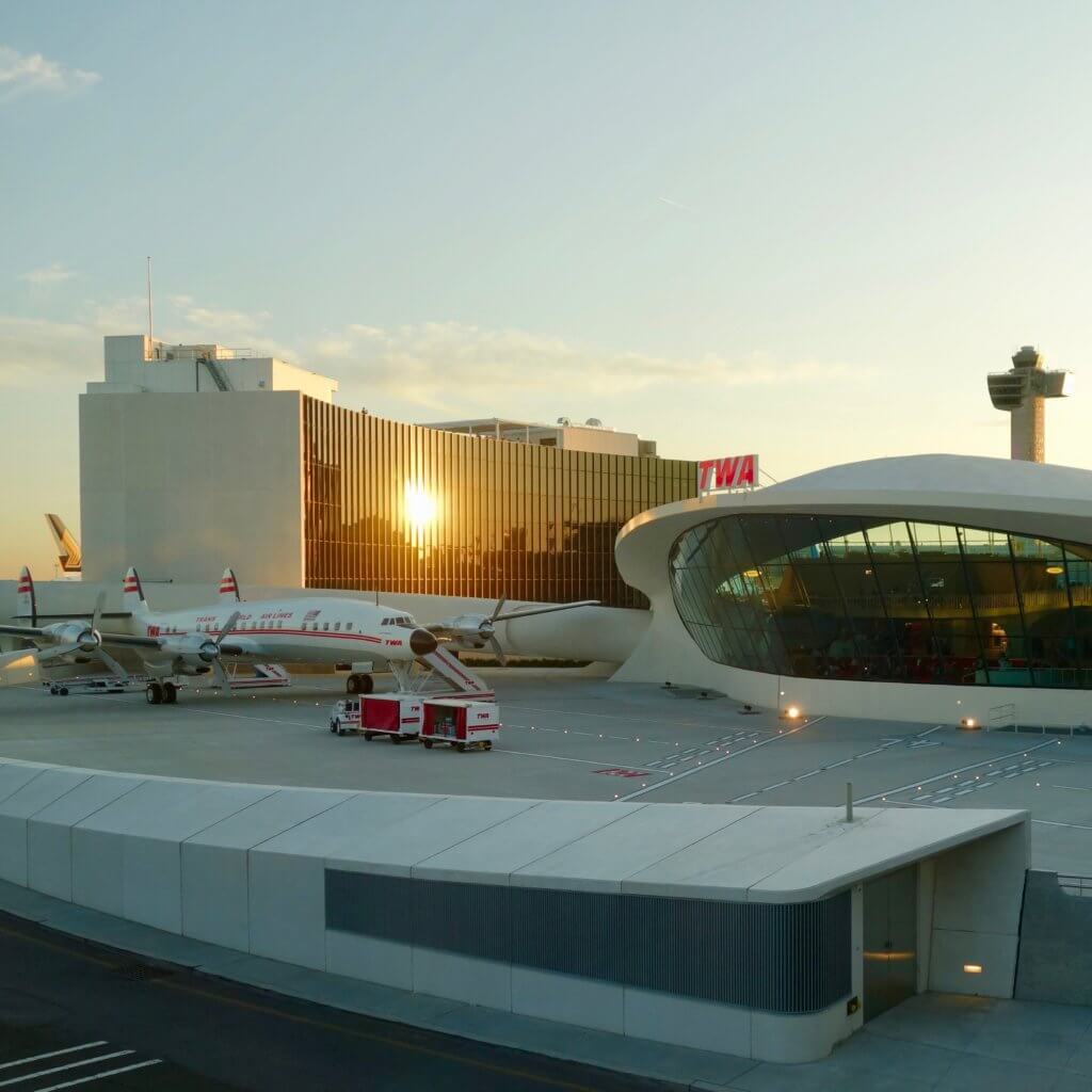 View looking from JFK Terminal 5 to TWA Hotel, which is located in the renovated 1962 TWA terminal. The hotel also has two modern towers where the rooms are located, and this photo shows one with the setting sun.