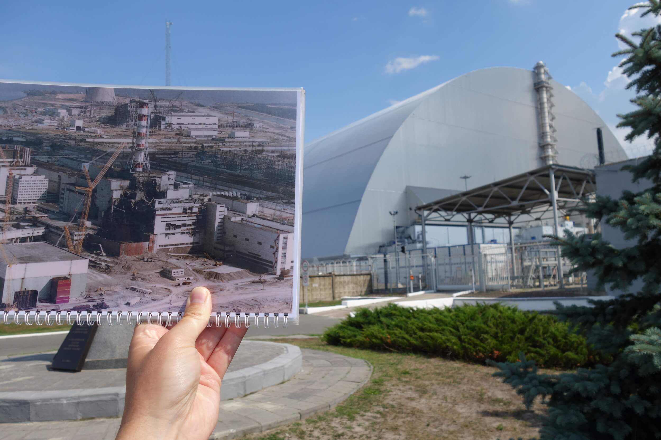 This shot compares a photo on a spiral notebook of Chernobyl Reactor 4 right after the explosion in April 1986 with the current day Reactor 4 which is covered up by a billion dollar sarcophagus.