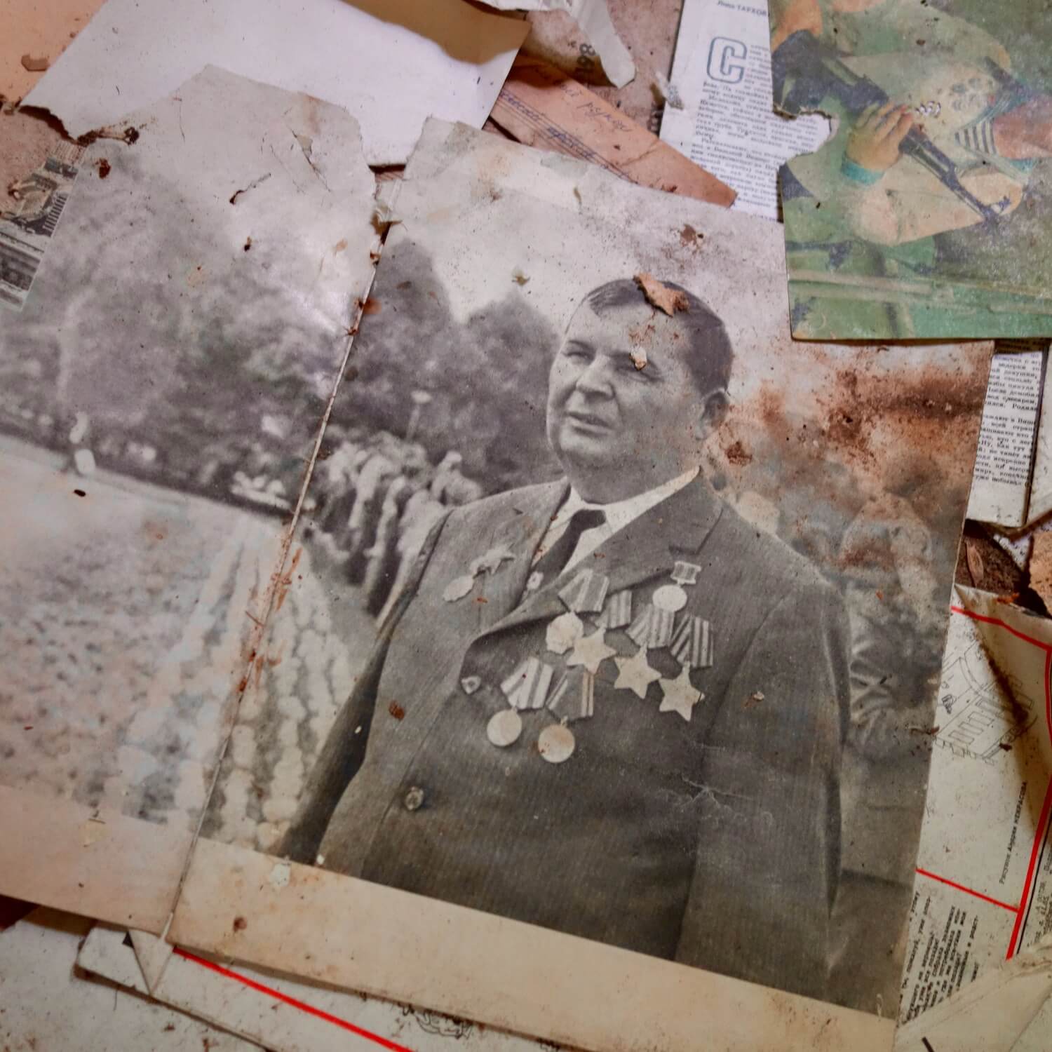 A magazine in Russian depicting a decorated general is part of many papers, periodicals and photos scattered on the floor in an abandoned concert hall in Prypyat, the closest city to Reactor #4.
