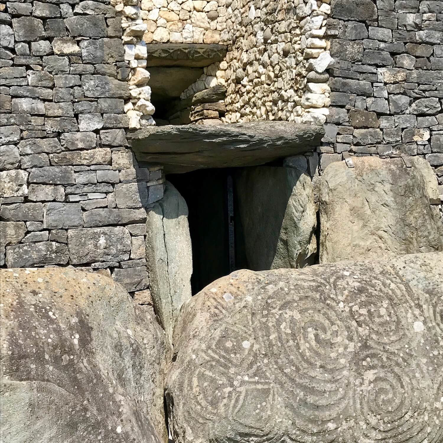 Hyroglifics etched in stones protect the ancient entrance to Newgrange site.