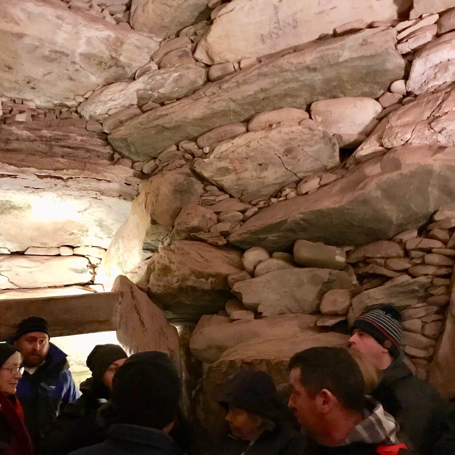 The dome inside the cave at the center of ancient Newgrange in Ireland during the winter solstice. There are rocks of various sizes perfectly squeezed together to create a water tight cavern.