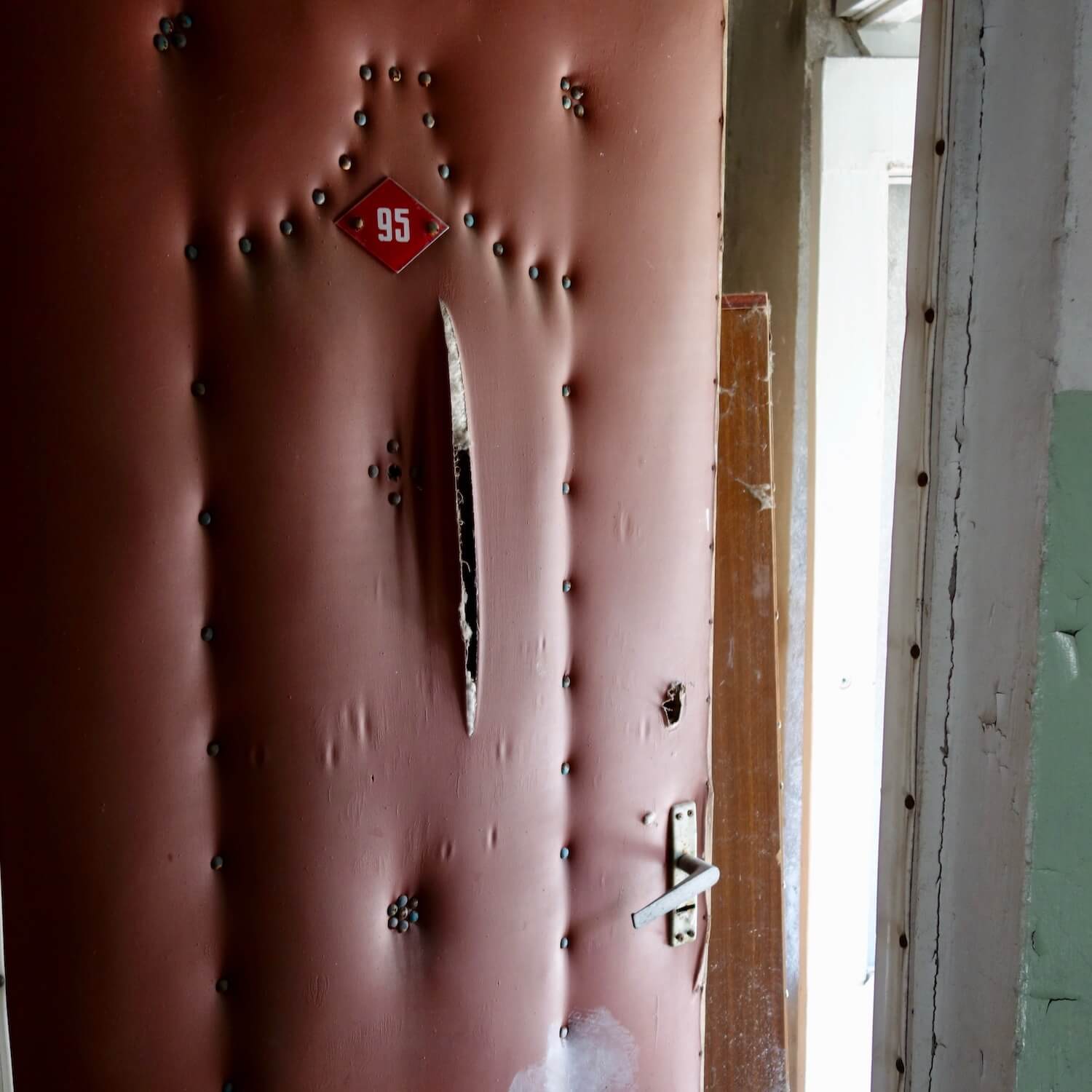 Door to apartment 95 in one of the housing complexes in the ghost town of Prypyat, which was abandoned following the April 1986 explosion of Chernobyl Reactor #4