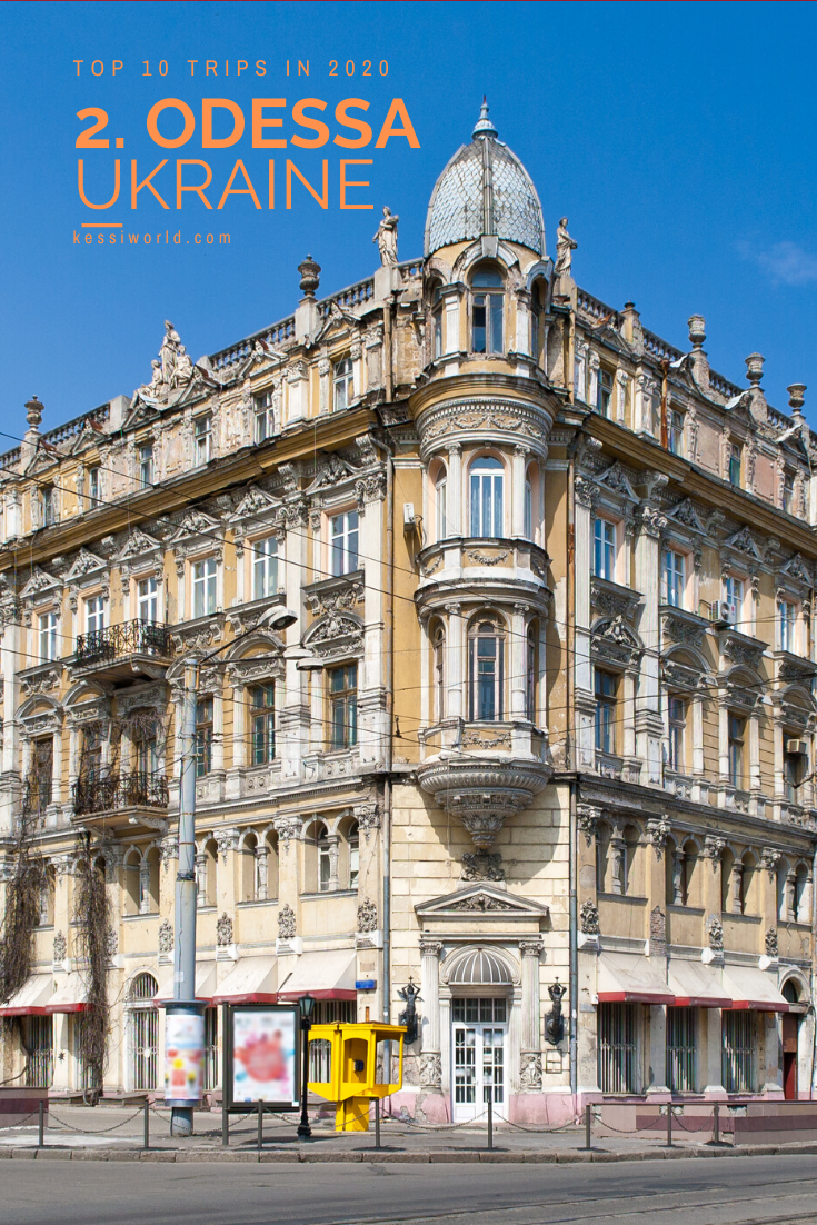 Odessa, Ukraine is depicted in this shot of an ornate 19th century apartment building with yellow hues of brick and plaster finished off by white/marble frames around the windows.