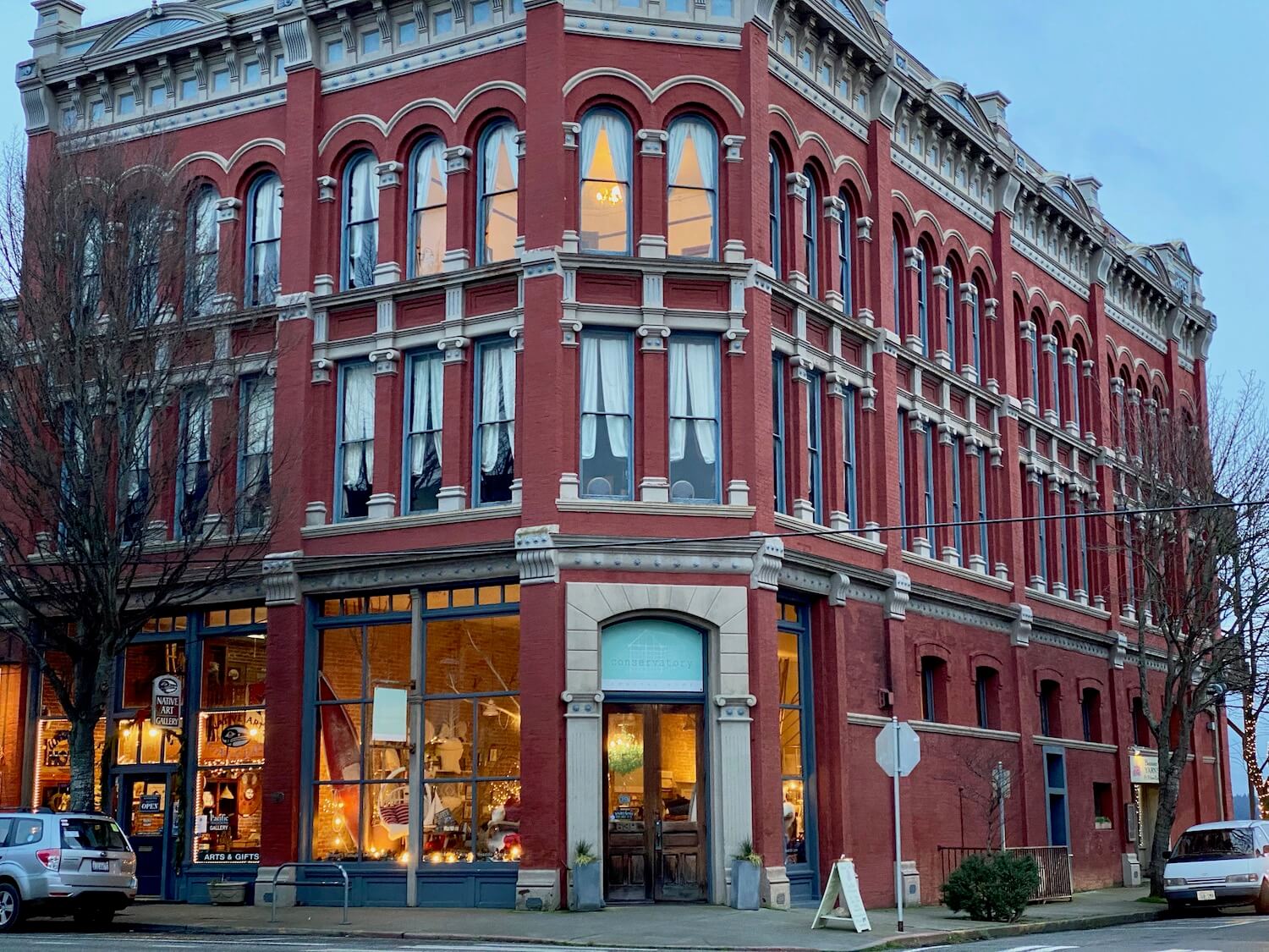 A great place to start or end an explore of the Olympic Peninsula is the victorian clad city of Port Townsend.  This shot shoes a three story building built in a 19th century ornate style with red brick and curtains in the window. Main Street of Port Townsend.