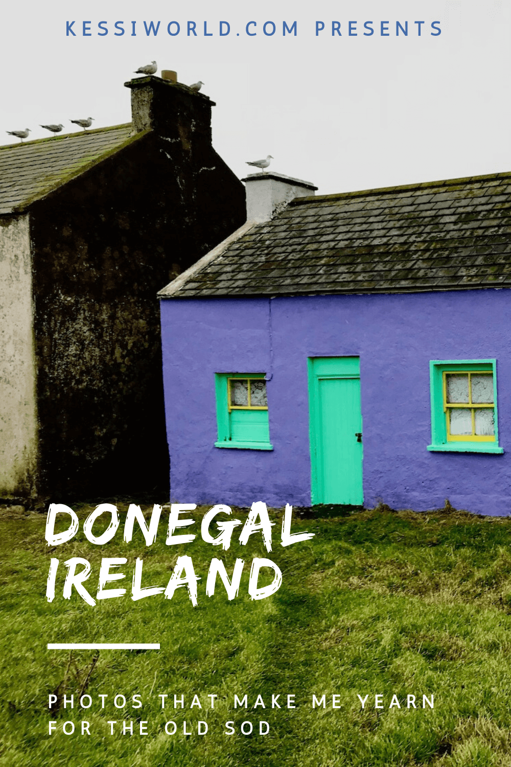 A traditional Irish home on Tory Island in County Donegal. The house is a vibrant purple with neon green trim and the three windows are framed with yellow color. The roof is slate with moss sporadically clinging to the surfaces and seagulls sit on top of the chimneys. The neighboring home is darker soot like black.