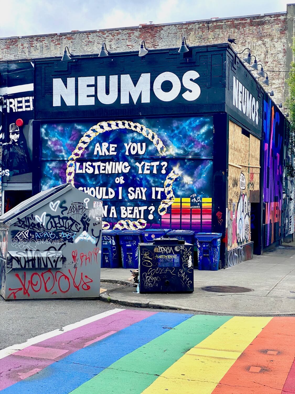 A nightclub on Capitol Hill near the CHOP zone shows colorful mural on the side of the walls that are otherwise painted black with a message that says, Are you listening yet or should I say it on a beat?