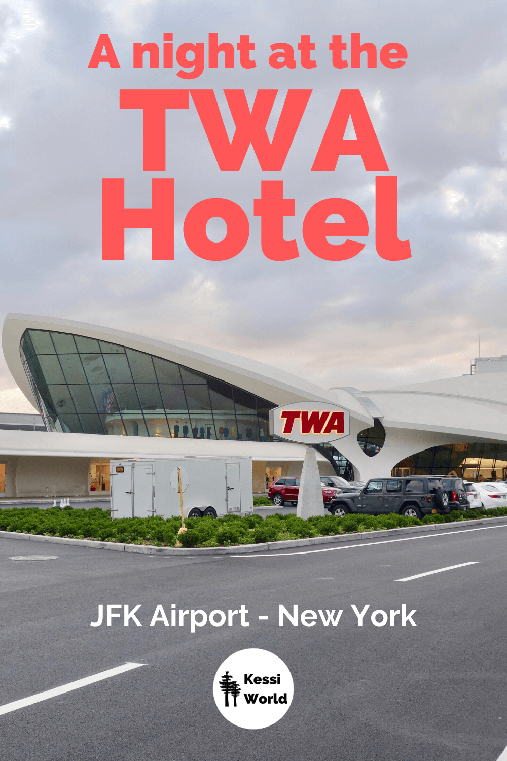 An outside shot of the TWA Hotel at JFK Airport in New York City. A vintage red TWA sign is positioned in front of the beautiful white building featuring the gentle lines of the Aero Saarinen designed airline terminal.