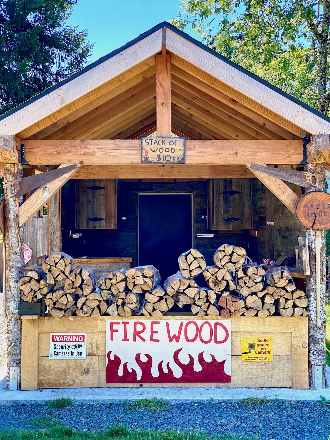 A firewood stand, covered by wood roof, offers batches of fir wood for ten dollars.  Rustic stands like this pop up everywhere on a Columbia Country day trip itinerary to Vernonia Scappoose and Sauvie Island. 