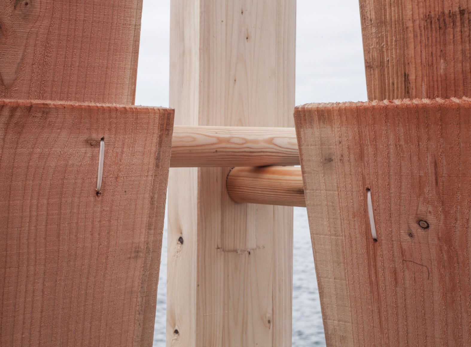 Up close shot of displaying the ways the pegs are perfectly cut to fit in the holes without any other assistance other than string.  