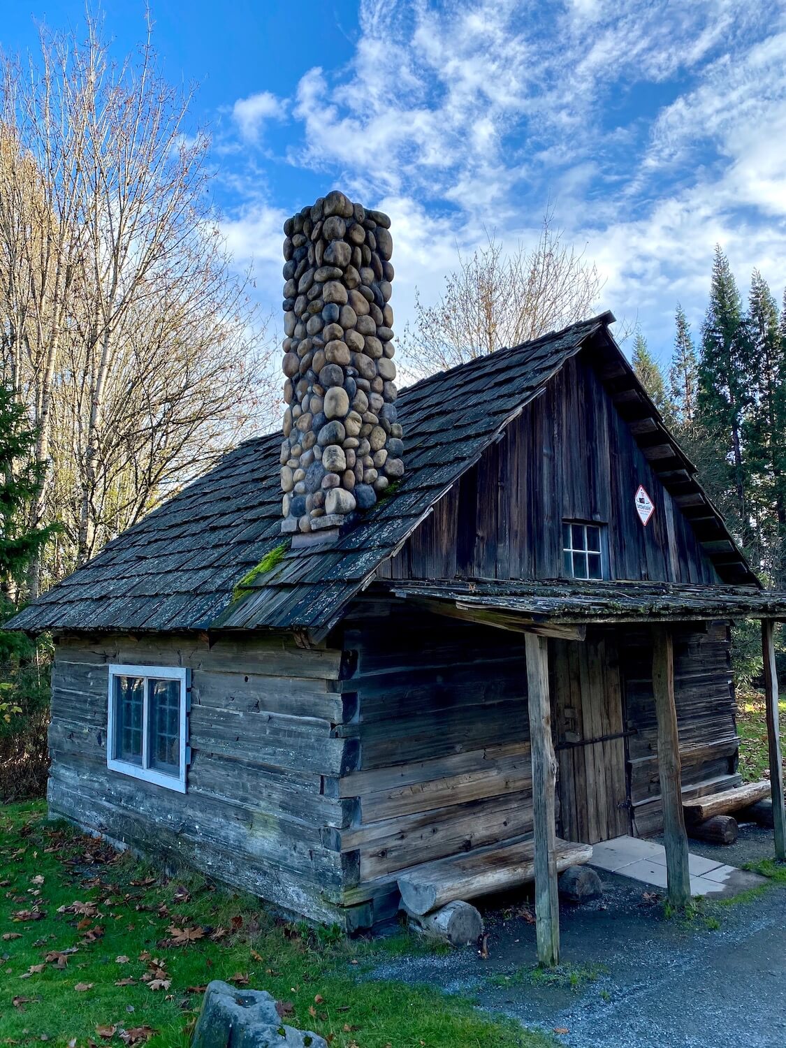 The Barker Cabin at the entrance to West Hylebos Wetlands Park is the oldest building in Federal Way, Washington. The structure is built by wood plants woven together with a wood shake roof and round stones piled up to create a chimney. There is a primitive front porch with two log seats.