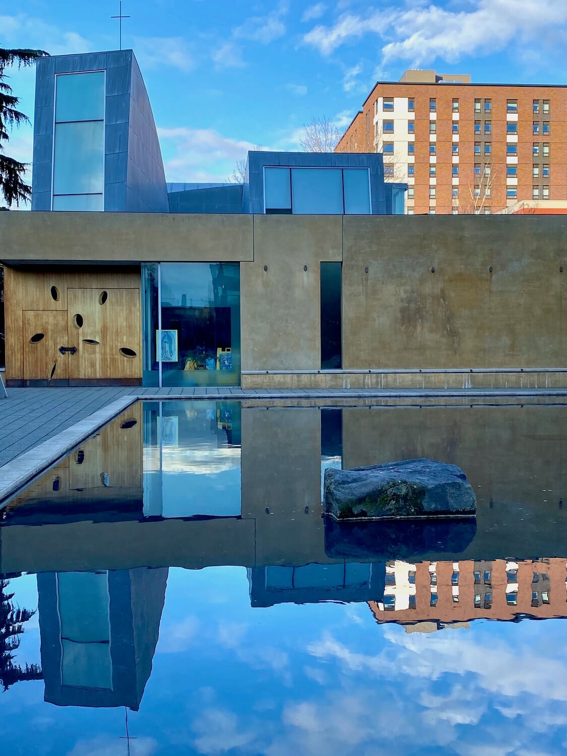 The Chapel of St. Ignatius on the campus of Seattle University offers a unique architecture with a variety of geometrical shapes towering over a rectangular reflection pool.  