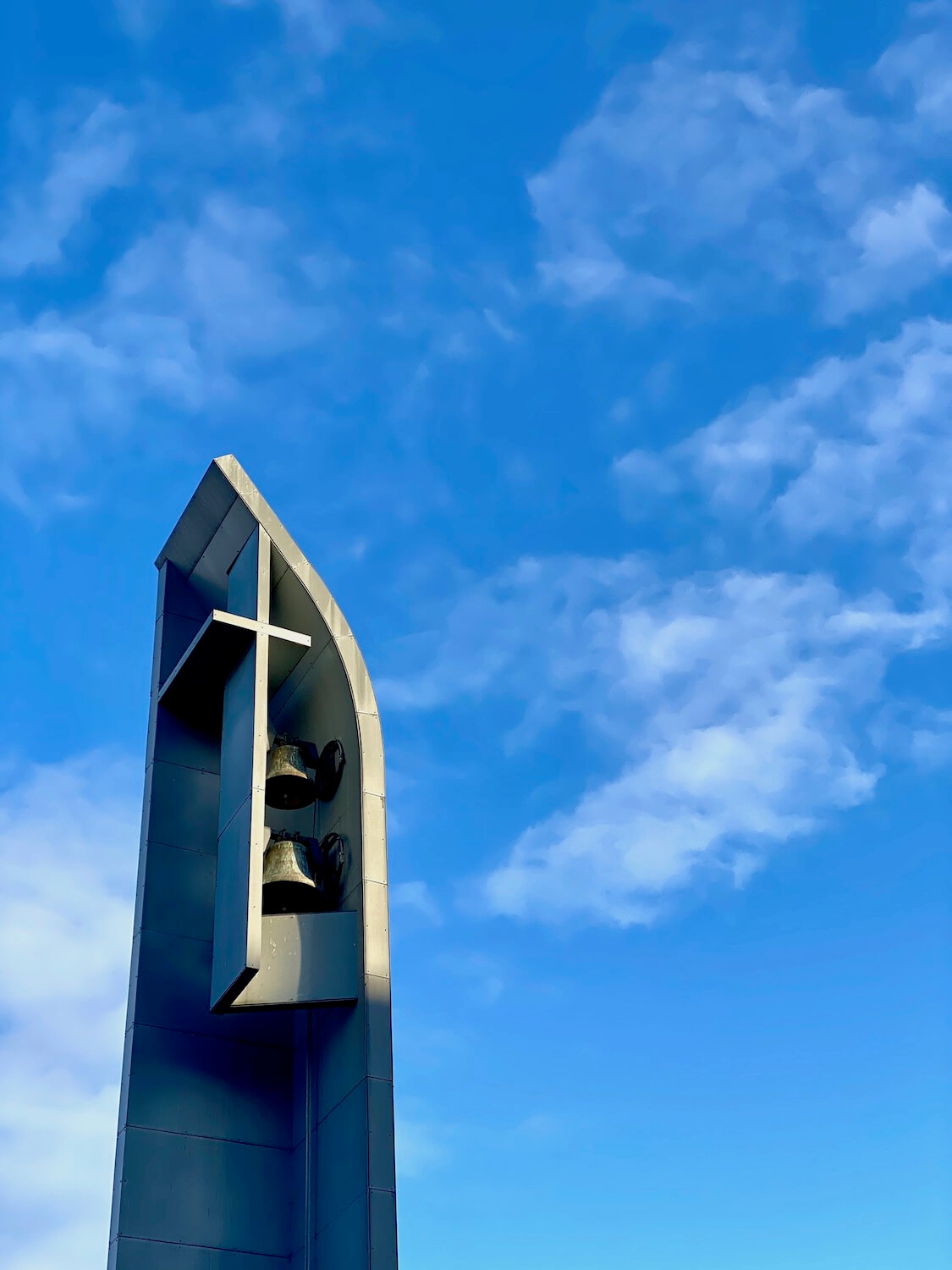 The bell tower of the Chapel of St. Ignatius reaches high up into the blue sky above the campus of Seattle University.  