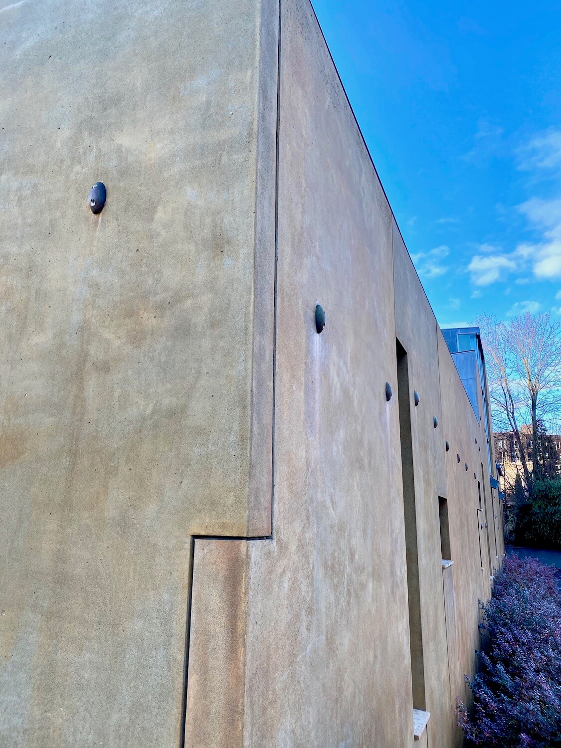 An interesting corner of the Chapel of St. Ignatius offers a angled perspective of the novel church design.  The walls are a concrete finish made to look like stucco found in the SW United States.  
