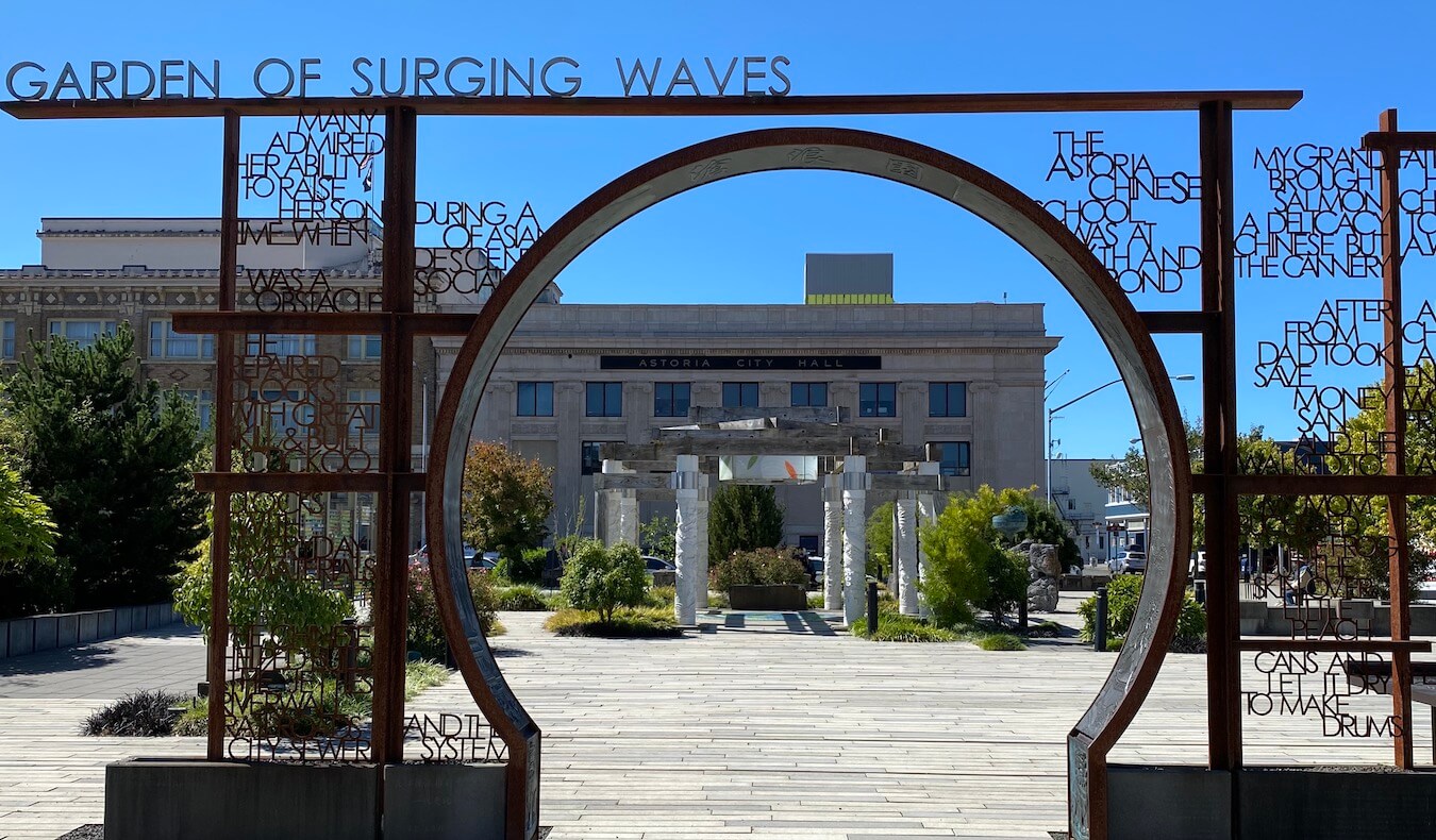 The rusted metal structure of the Garden of the Waves park in Downtown Astoria offers various phrases about the history of Chinese Americans in this harbor down.  
