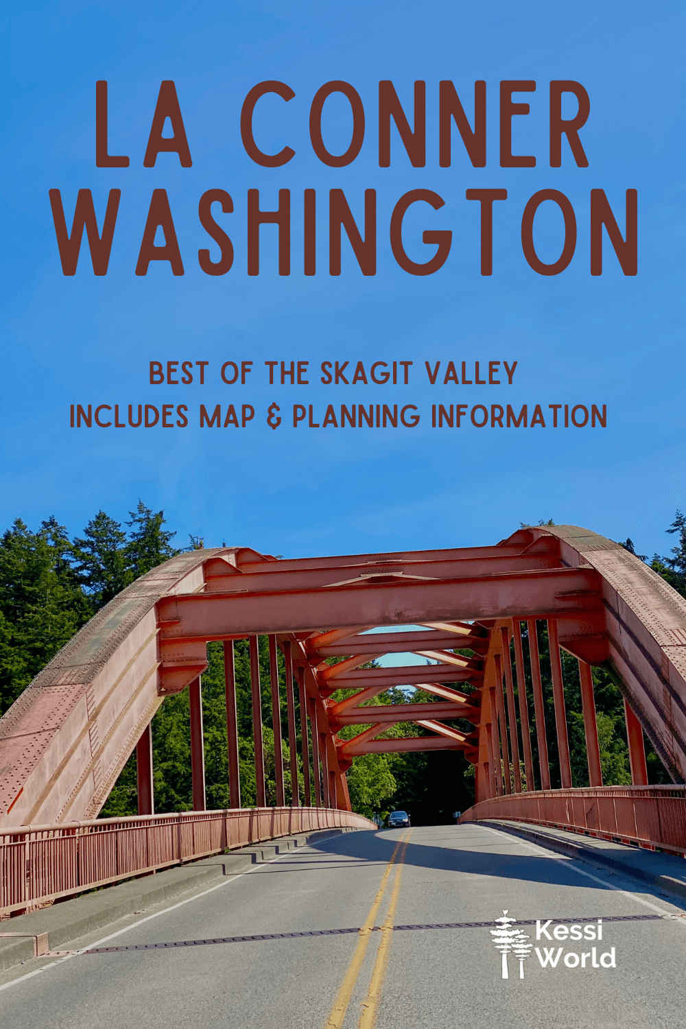 This Pinterest pin shows the pink colored Rainbow Bridge, which connects the Swinomish Village with the town of La Conner, Washington.  The sky above is blue and road on the bridge is gray pavement with a car coming in the distance. 