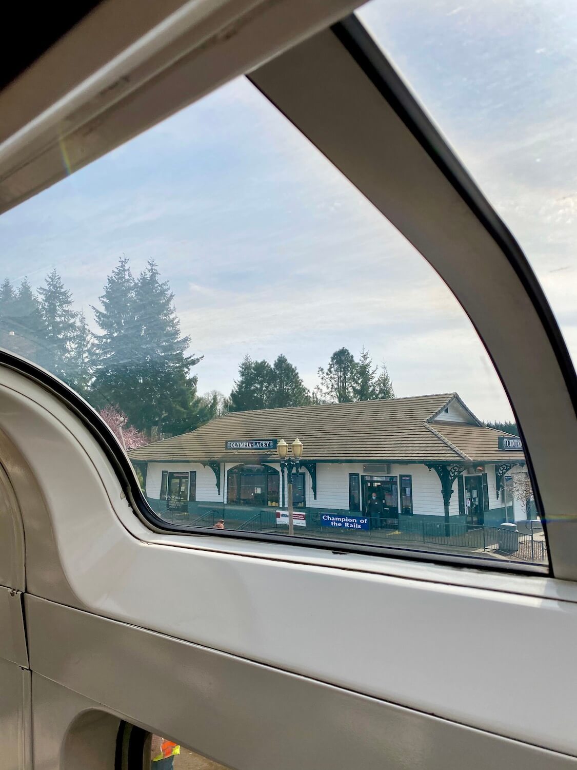 The Coast Starlight stops at the Olympia/Lacey station which can be seen outside the curved window of the scenic dome car on the train. 