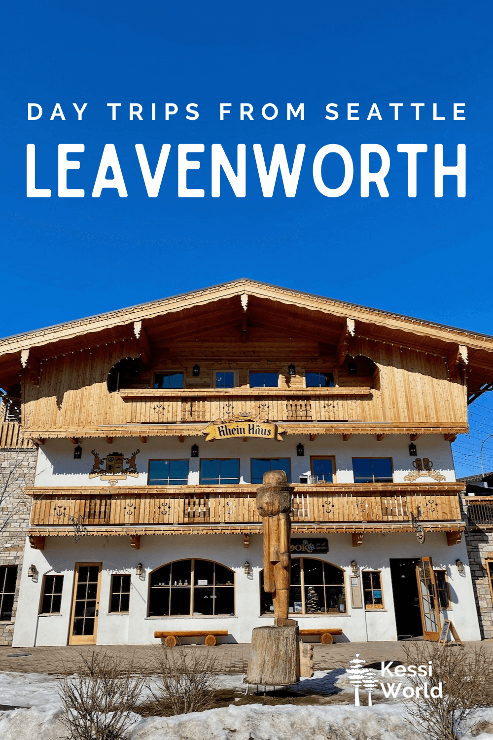 This Pinterest pin displays white letters that read "day trips from Seattle" and highlights Leavenworth. The photo shows a German chalet style building with brown woodwork and white stucco siding under a bright blue sky.