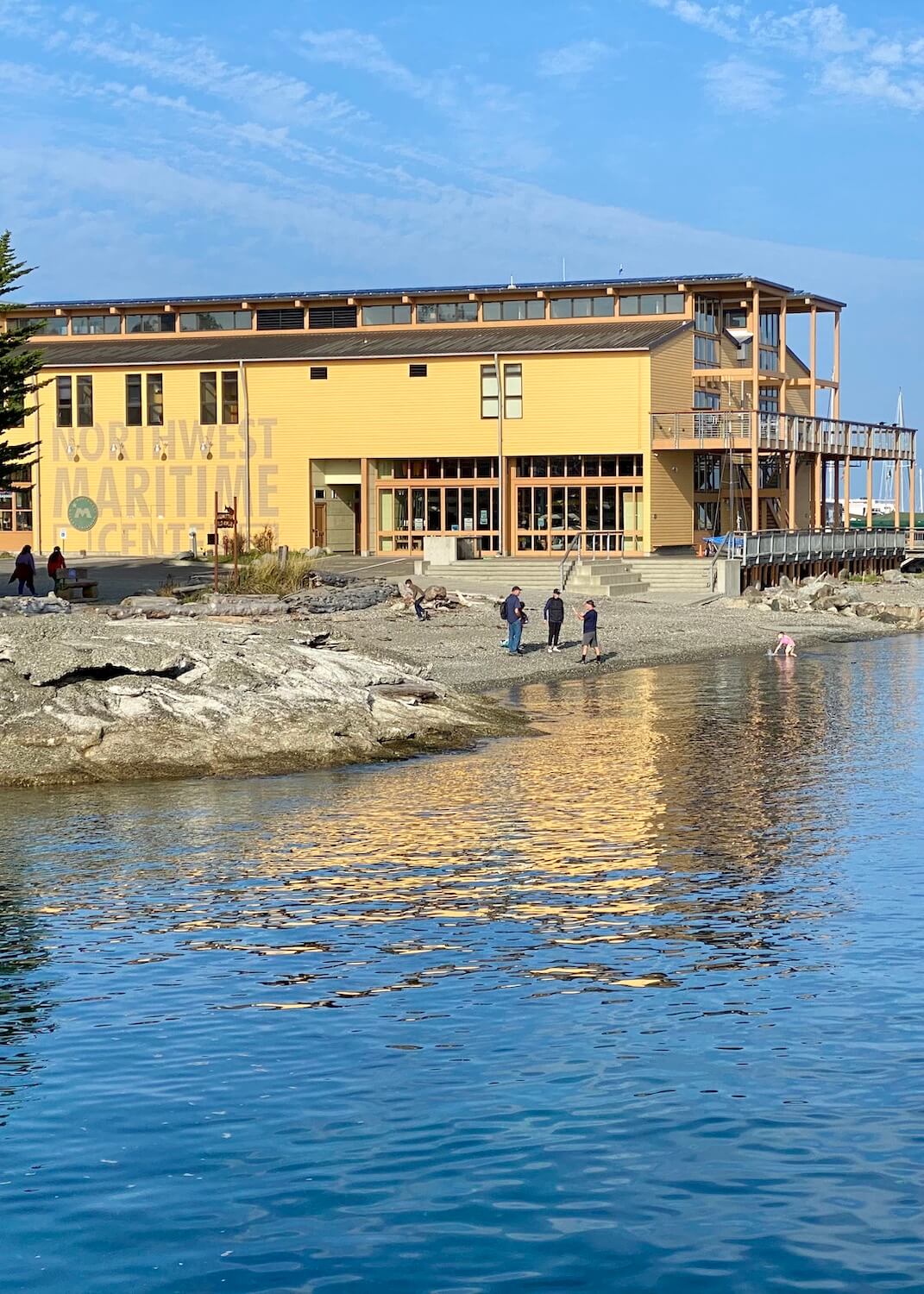 A great thing to do in Port Townsend, Washington is to go to the Maritime Center and watch people building wooden boats.  The building is a off yellow color in a modern wooden style of architecture and it leads to a beach along the Salish Sea. 