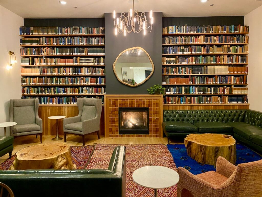 The lobby of the Society Hotel is a cozy place to sit and read. There is afire roaring and shelves of books. Comfortable looking couches and chairs are strategically placed throughout the room.