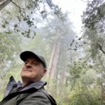 Matthew Kessi smiles for a selfie among a redwood forest near Brookings Oregon