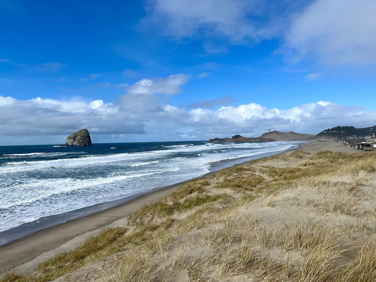 A sweeping view of Pacific City, one of the best Oregon Coast Towns for wide sandy beaches and peace and quiet.