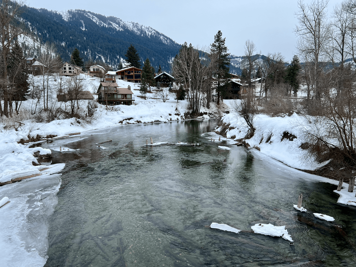 Leavenworth Washington is the perfect location to try a nature forward vacation. The icy Wenatchee River winds through hillsides covered in snow with a scattering of cabins underneath majestic mountains.