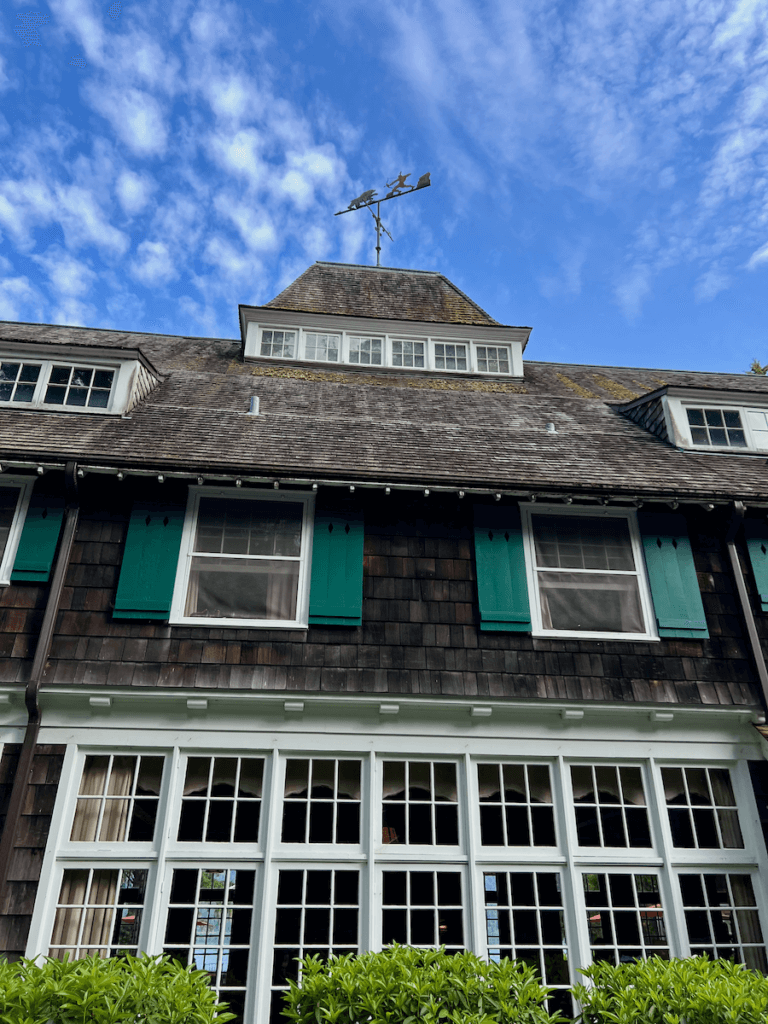 Lake Quinault Lodge is a solid cedar shake hotel in the middle of Olympic National Park and a temperate rainforest. But today the sky is blue and the it brings out the bright green of the shutters on the second floor of the hotel.