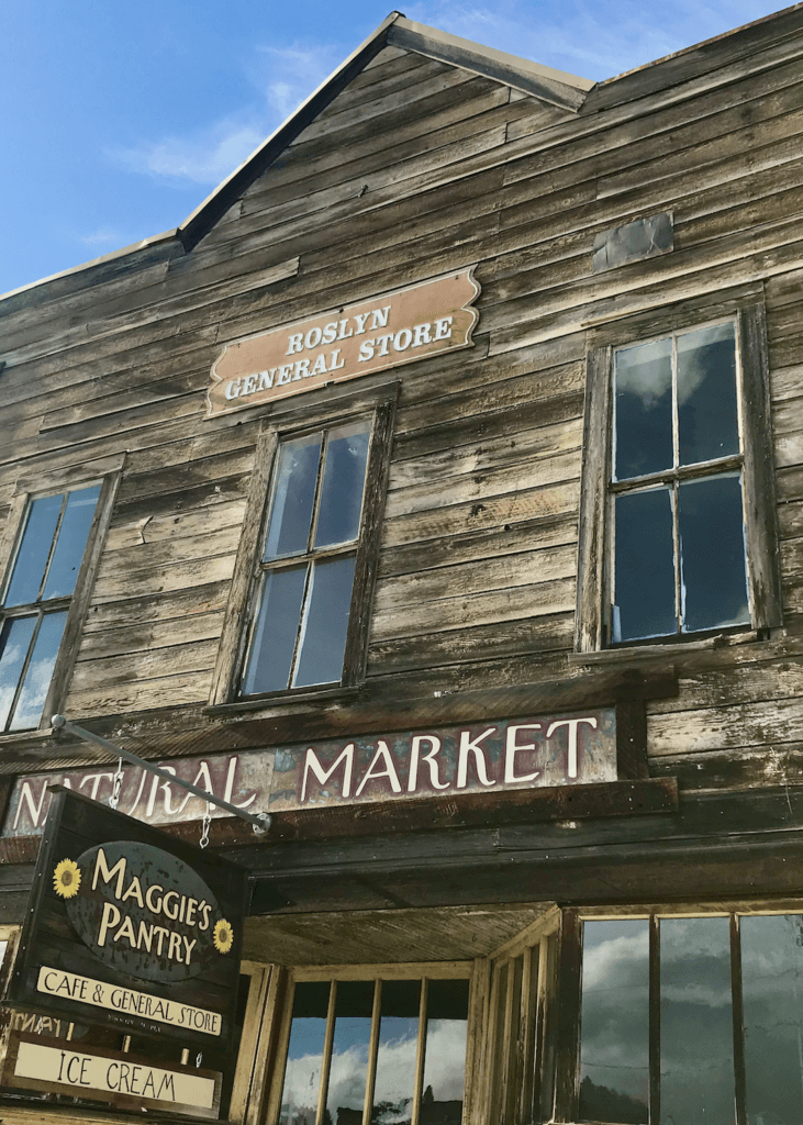 A pioneer style market building in downtown Roslyn, Washington is a jewel in the Cascade Mountains. The weathered wood gives a whimsical feel to the store on a blue sky day.