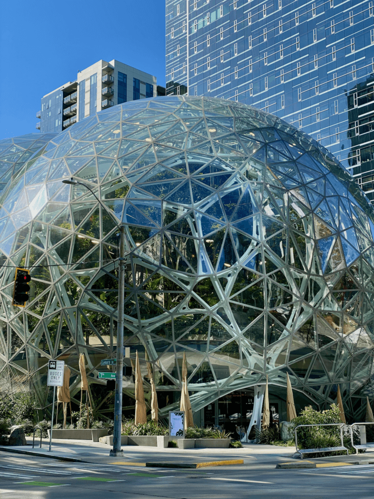 Amazon spheres in downtown Seattle shows a futuristic architecture design underneath another glass tower.