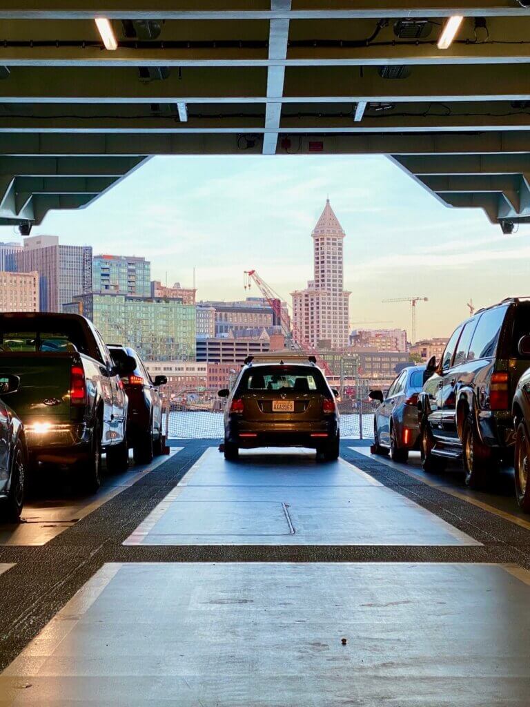 Smith Tower can be seen through the main deck of a Washington State Ferry pulling up to the Coleman Dock of Downtown Seattle.